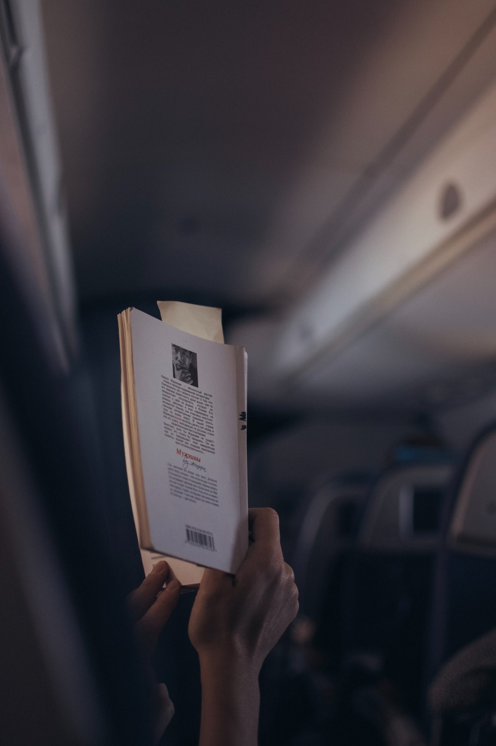 reading a book on airplane 